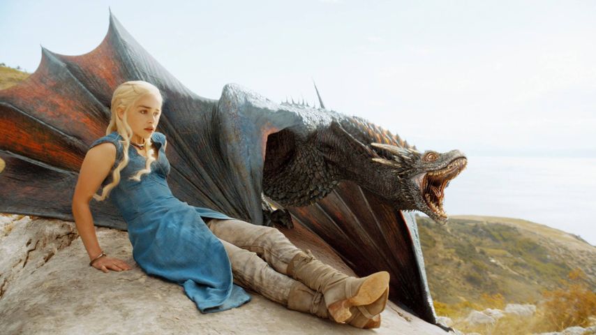 Deanerys und ihr Drache auf einem Felsen